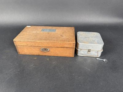 an old wooden box with a key and a small metal box