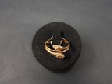 a close up of a gold ring on a black surface