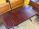 a brown leather table with a brown leather top