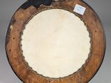 a brown plate with a black rim on a white table