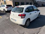 a white car parked in a parking lot next to a building