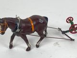 a toy horse pulling a sleigh with a man on it