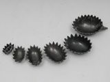 four silver spoons with spikes and spikes on them