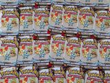 a pile of pokemon trading cards sitting on top of a table