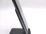 a cell phone that is on a stand on a table
