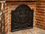 a brick fireplace with an ornate design on the mantle