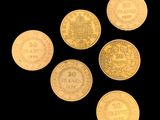 six gold coins are arranged in a circle on a black background