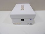 a white box with gold writing on it on a table