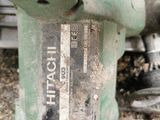 a close up of a green drill on the ground