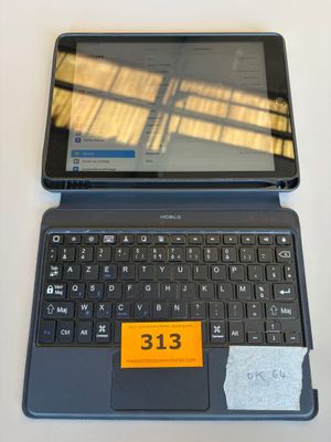 a laptop and a tablet on a table with a price tag on it