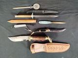several different types of knives are lined up on a table