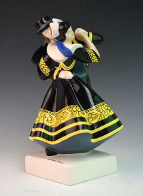 an image of a figurine of a woman in a black and yellow dress