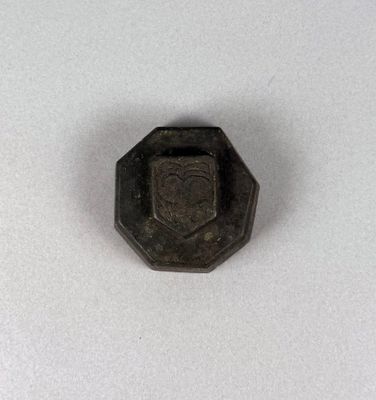 a close up of a small metal object on a white surface