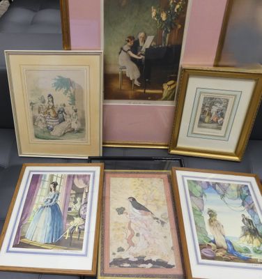 several framed pictures of people and birds on display in a glass case