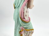 figurine of a woman in a blue dress with a pink shawl
