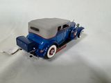 a toy car that is sitting on a white surface