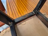 a close up of a wooden table with a chair on it