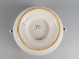 underside view of a porcelain bowl with a gold rim and green decoration