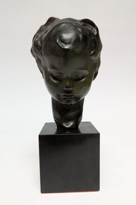 sculpture of a head of a child on a black marble base