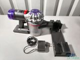 a vacuum that is sitting on a table next to a charger