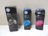 three hp ink cartridges are lined up on a white surface