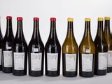 six bottles of wine are lined up in a row on a table