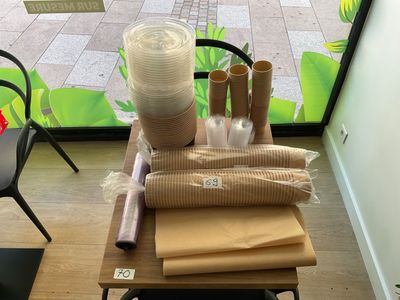 a table with rolls of paper and a roll of toilet paper on it