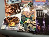 a lot of comic books on the table