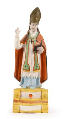 figurine of a pope in a robe and hat on a pedestal
