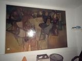 a painting on the wall of a room with a chair and a desk
