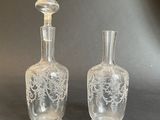 two clear glass vases sitting next to each other on a table