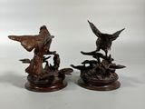 pair of antique carved wood ducks on a branch with birds