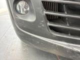 a close up of the front of a car with a dirty grille