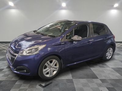 the blue car is parked in the garage on the checkered floor