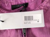 a close up of a label on the back of a purple pants
