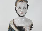a figurine of a woman in a blue dress