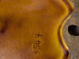 a close up of a brown vase with writing on it