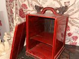 a small red box sitting on top of a wooden table