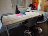 a desk with two chairs and a computer on it