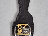 black leather key fob with a gold z logo on it