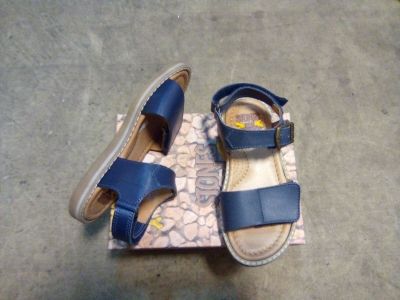 a pair of sandals that are on top of a box
