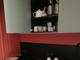 a kitchen with a stove, sink, and cabinets in it