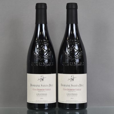 two bottles of wine sitting on top of a table next to each other