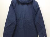 a blue jacket hanging on a wall in a room