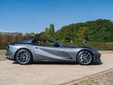 the silver sports car is parked in the parking lot