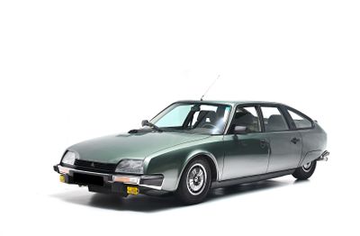 a green car that is parked on the side of the road