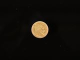 a close up of a gold coin on a black background