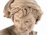 a statue of a boy with a hat on his head
