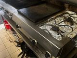 a stove top with two burners on it in a kitchen