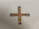 an image of a gold cross with multi colored stones on it
